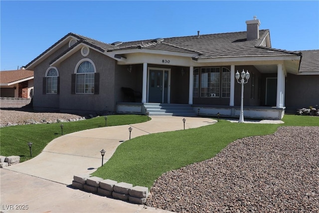 view of front of house featuring a front lawn and covered porch