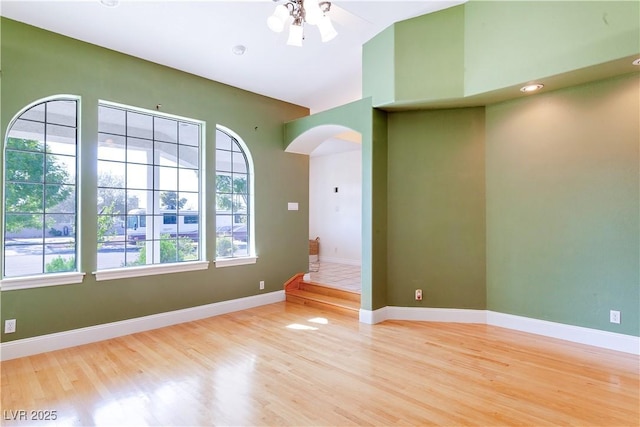 empty room featuring ceiling fan and light hardwood / wood-style flooring