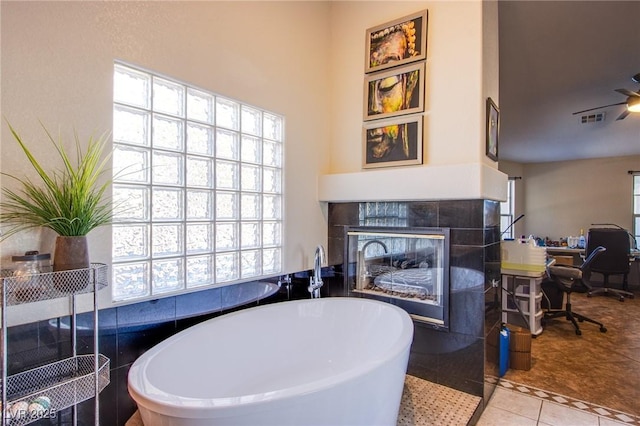 interior space featuring a fireplace, plenty of natural light, and a bathtub