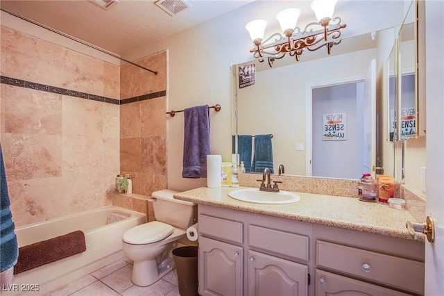 full bathroom featuring tiled shower / bath combo, tile patterned flooring, toilet, a textured ceiling, and vanity