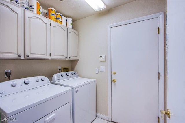 laundry room with cabinets and separate washer and dryer