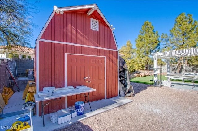 view of outbuilding featuring a pergola