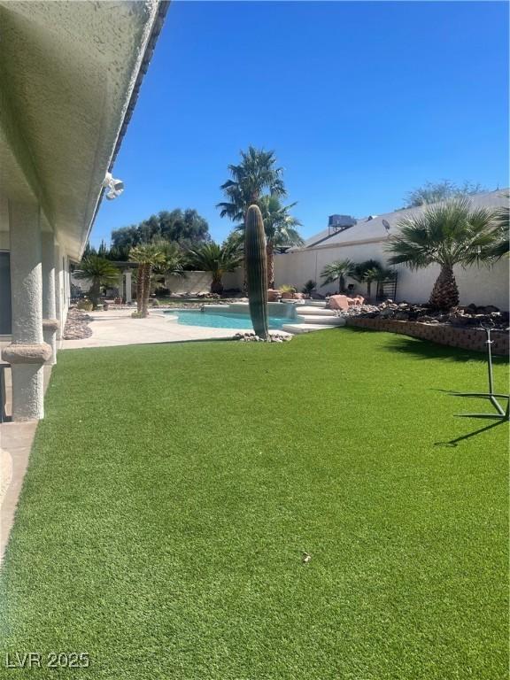 view of yard with a fenced backyard and a fenced in pool