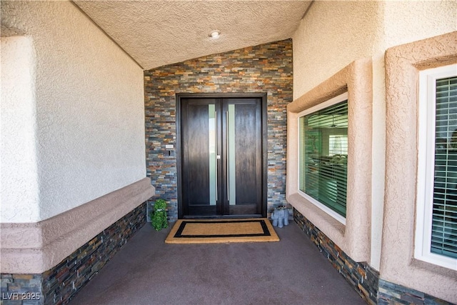 entrance to property with stucco siding