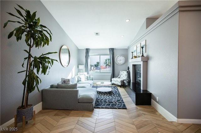 living room featuring recessed lighting, baseboards, visible vents, and a glass covered fireplace