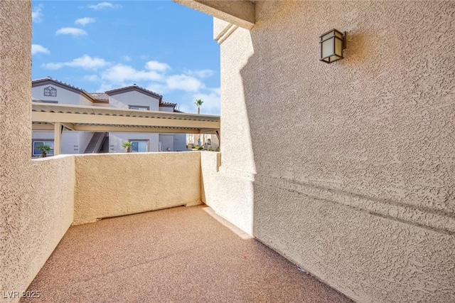 view of patio featuring a balcony