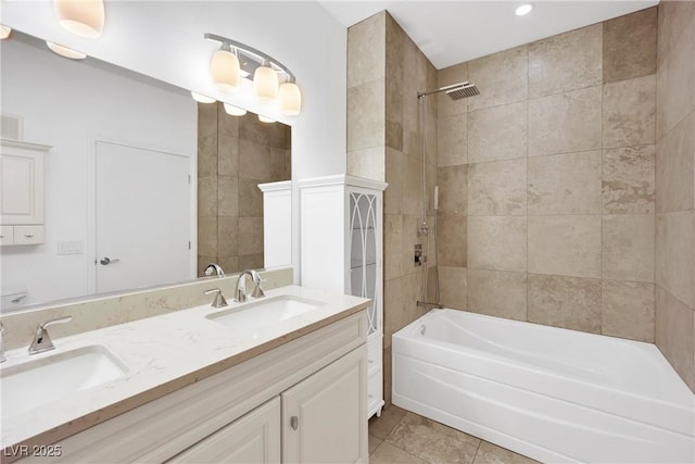 bathroom with tiled shower / bath, vanity, and tile patterned flooring