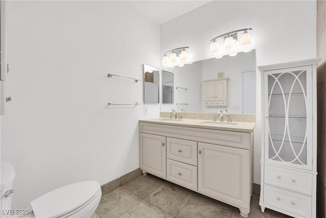 bathroom featuring vanity, tile patterned floors, and toilet