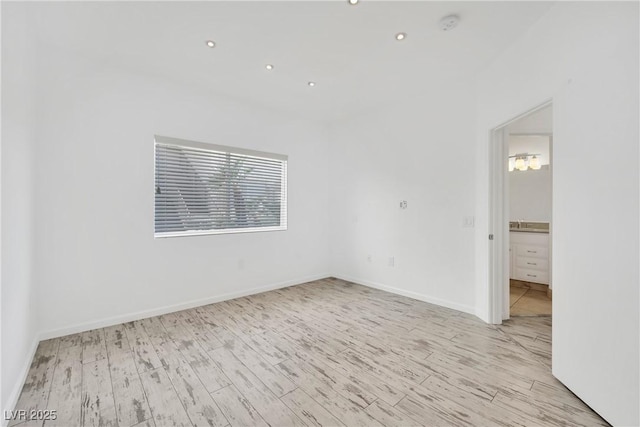 spare room with light hardwood / wood-style flooring