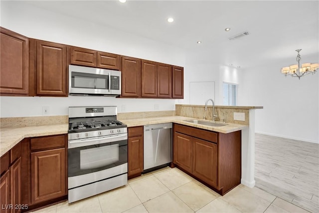 kitchen featuring stainless steel appliances, sink, light tile patterned floors, and kitchen peninsula