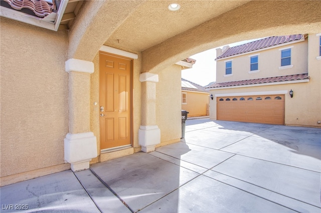 view of exterior entry featuring a garage