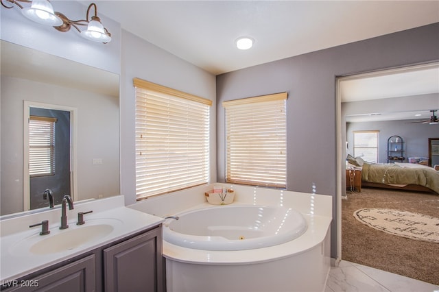 bathroom with vanity, a bathtub, and ceiling fan