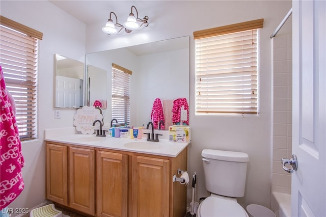 full bathroom with vanity, toilet, and  shower combination