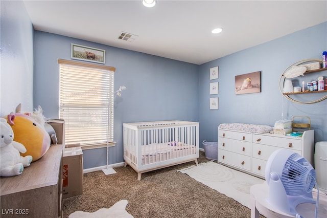 bedroom featuring a crib and dark colored carpet