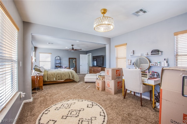 bedroom featuring multiple windows, an inviting chandelier, and carpet