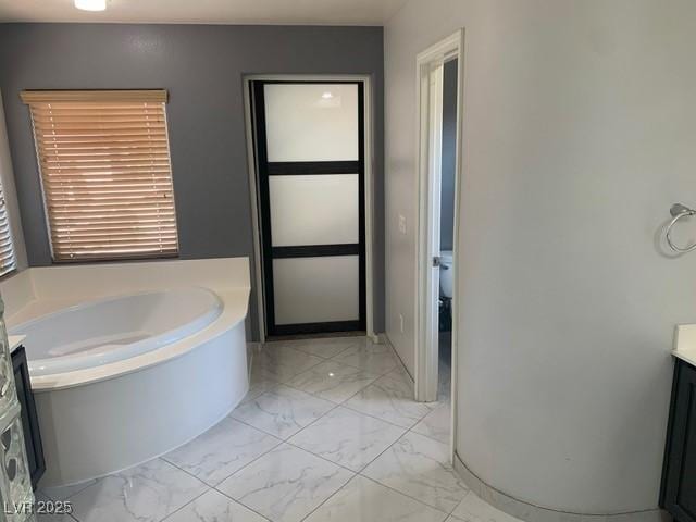 bathroom featuring vanity and a bath