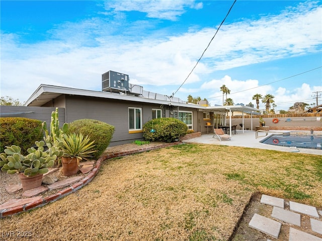 rear view of property with central AC, a yard, and a patio