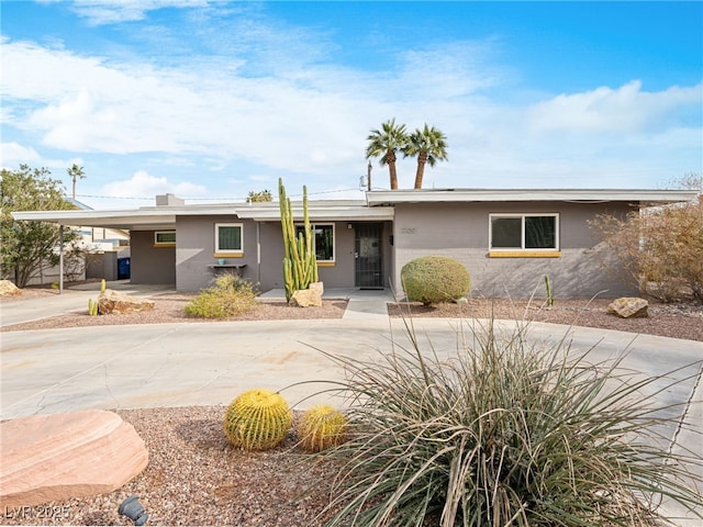 ranch-style home with a carport