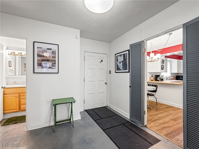 interior space with sink, concrete floors, and a chandelier