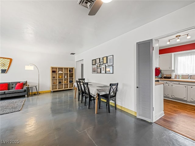 dining room featuring concrete flooring