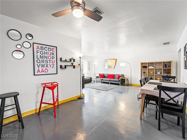 dining space featuring ceiling fan, concrete floors, and a textured ceiling