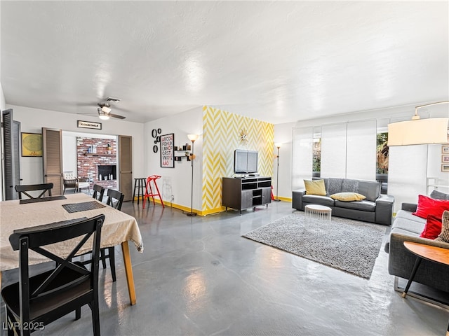 living room featuring ceiling fan and a textured ceiling