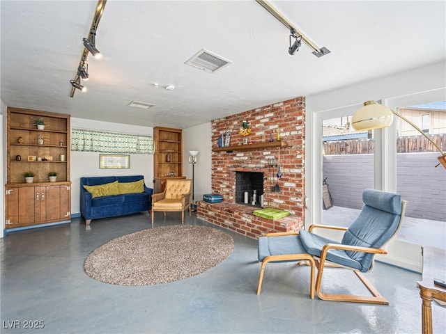 living room with a fireplace and track lighting