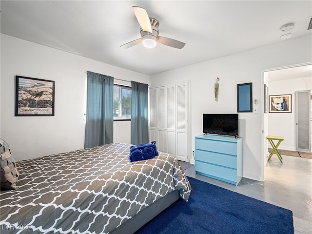 bedroom with concrete flooring, a closet, and ceiling fan