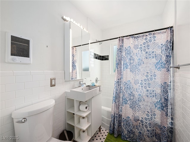 full bathroom featuring tile walls, sink, shower / tub combo, and toilet