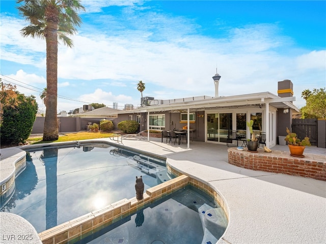 view of swimming pool featuring a patio and an in ground hot tub