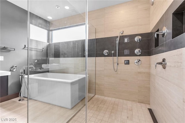 bathroom featuring shower with separate bathtub