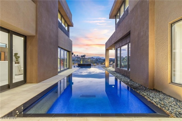 view of pool at dusk