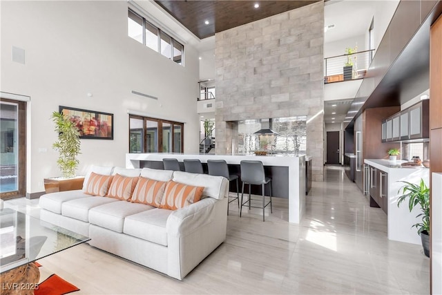 living room featuring a towering ceiling