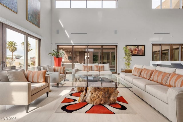 living room featuring a towering ceiling