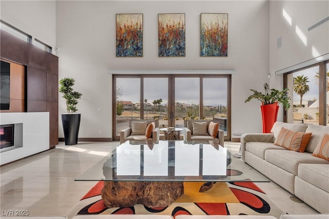 living room featuring french doors and a towering ceiling