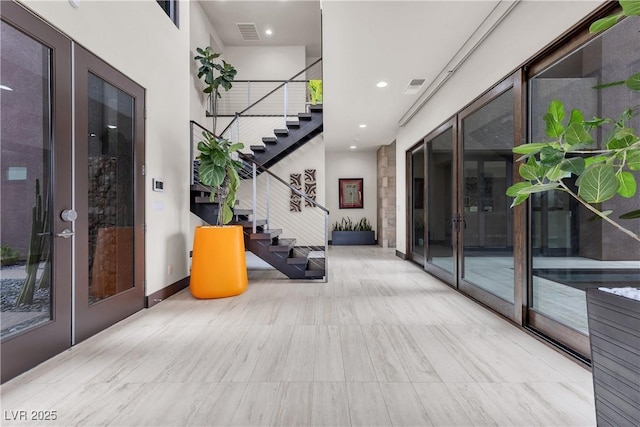 interior space featuring a high ceiling and french doors