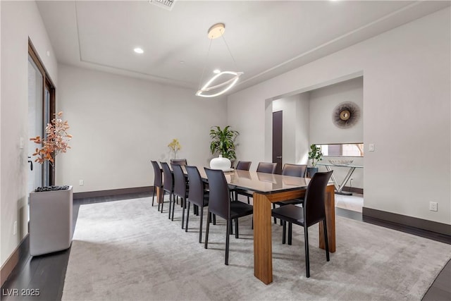 dining space featuring a notable chandelier and dark wood-type flooring