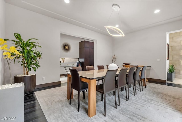 dining space featuring wood-type flooring and a chandelier