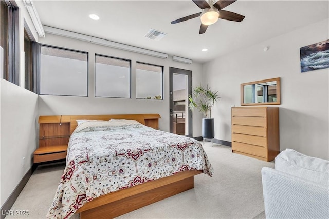 bedroom featuring ceiling fan, light colored carpet, and a baseboard heating unit