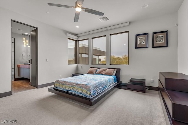 bedroom featuring carpet flooring, ceiling fan, and ensuite bath