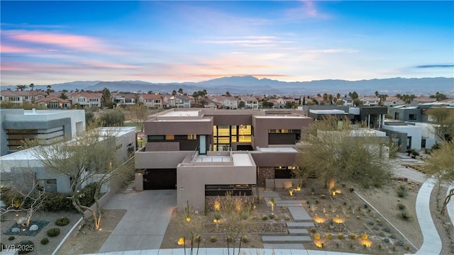 view of front of home with a garage and a mountain view