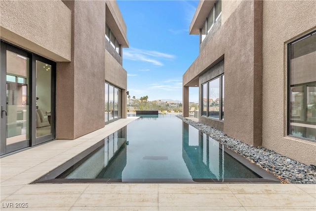 view of swimming pool with a water view