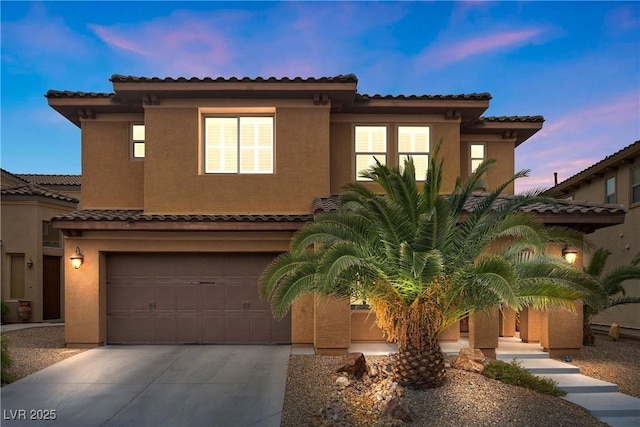 mediterranean / spanish-style home featuring a garage