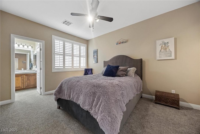 bedroom with ceiling fan, ensuite bathroom, and carpet