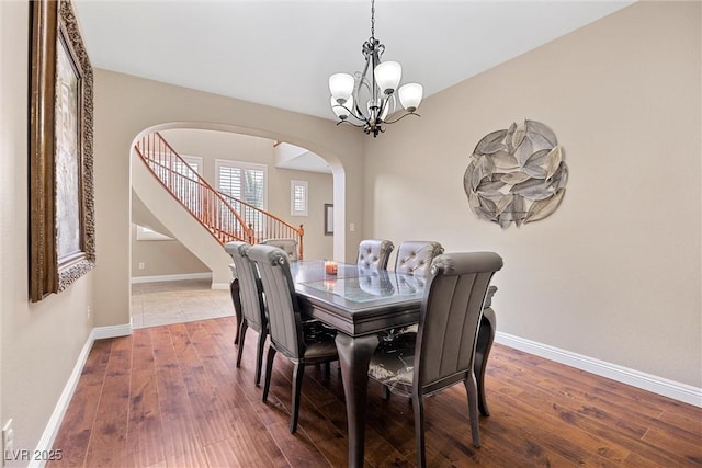 dining space featuring an inviting chandelier and wood-type flooring