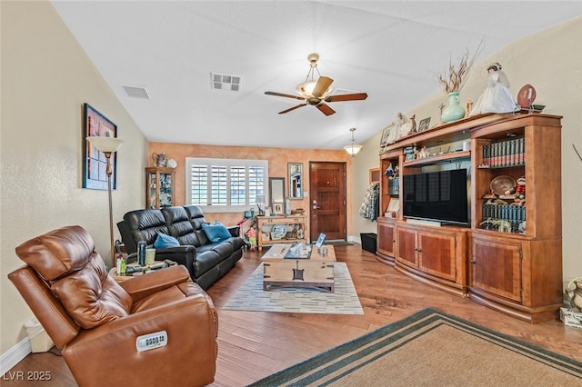 living room with vaulted ceiling, ceiling fan, and light hardwood / wood-style flooring