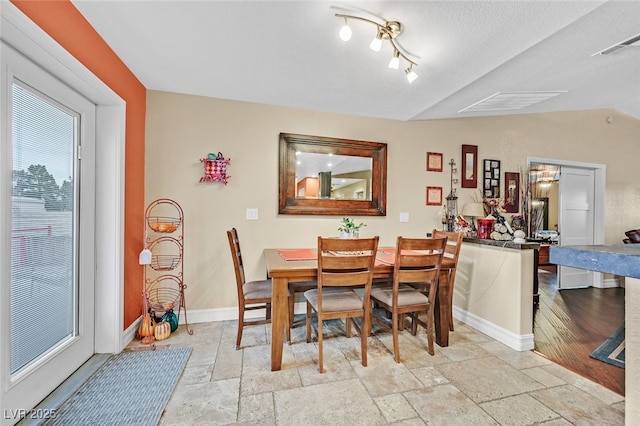 dining room featuring vaulted ceiling