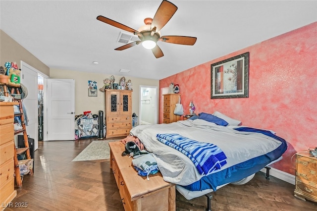 bedroom with dark hardwood / wood-style floors and ceiling fan