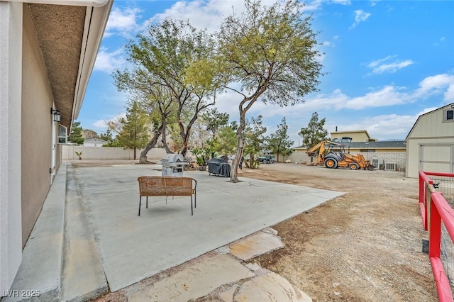 view of patio with a grill and a storage unit