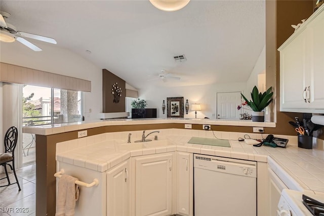 kitchen featuring white cabinets, tile counters, kitchen peninsula, and dishwasher